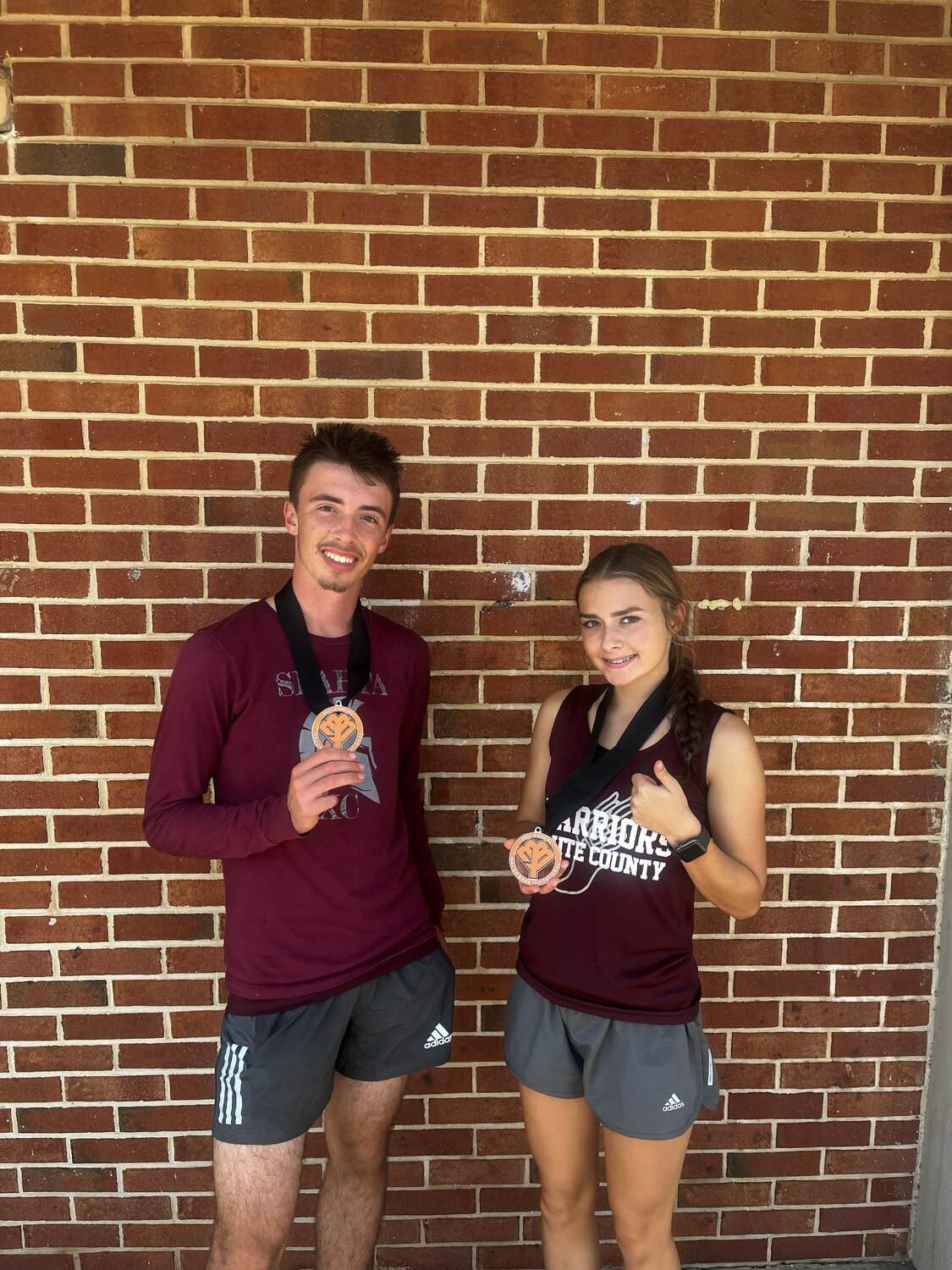 Gabriel Wiles and Emma Nash with their medals